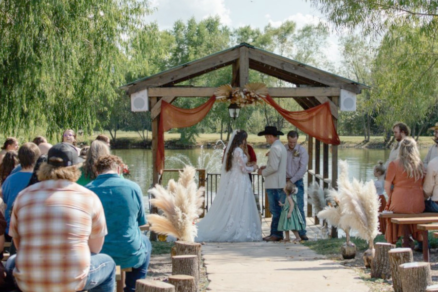 Boho wedding ceremony with wood and pampas